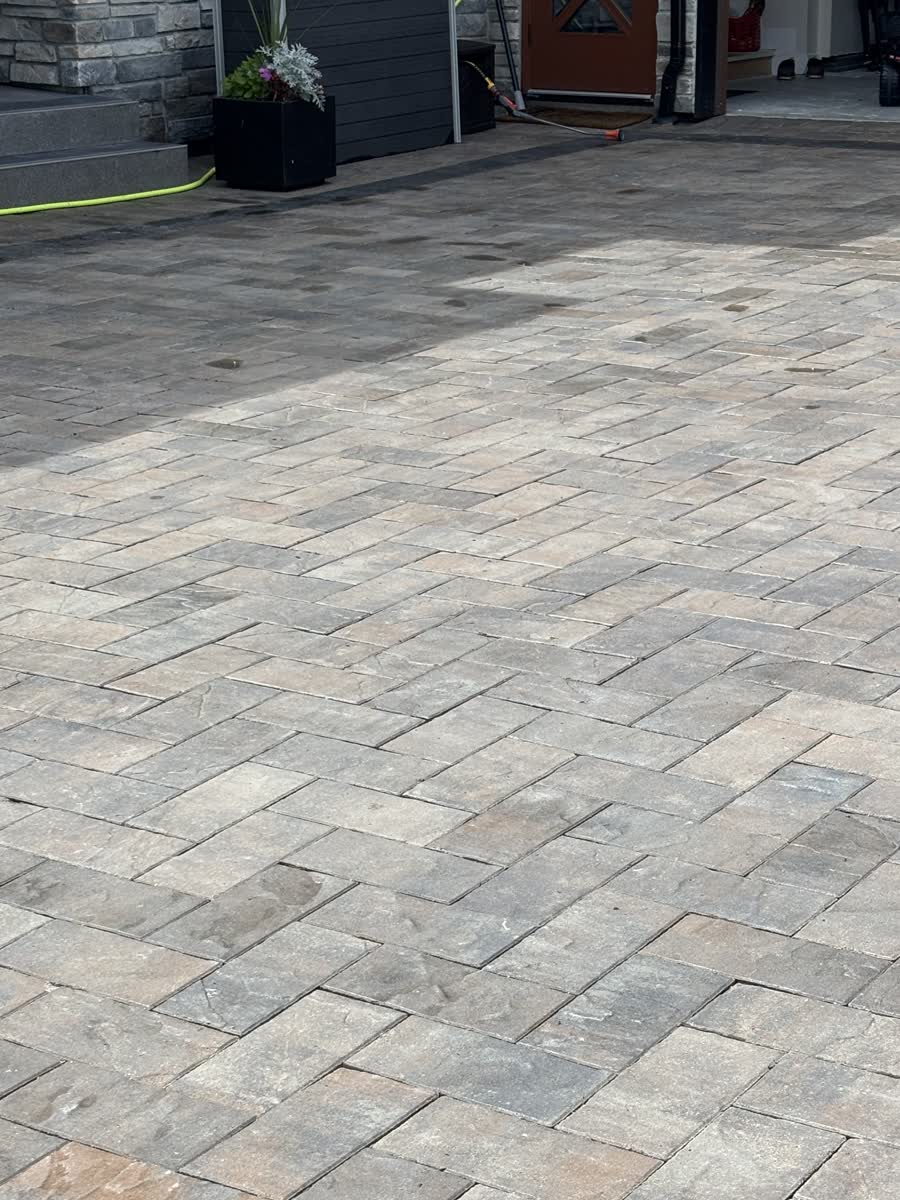 Clean herringbone paver driveway after pressure washing